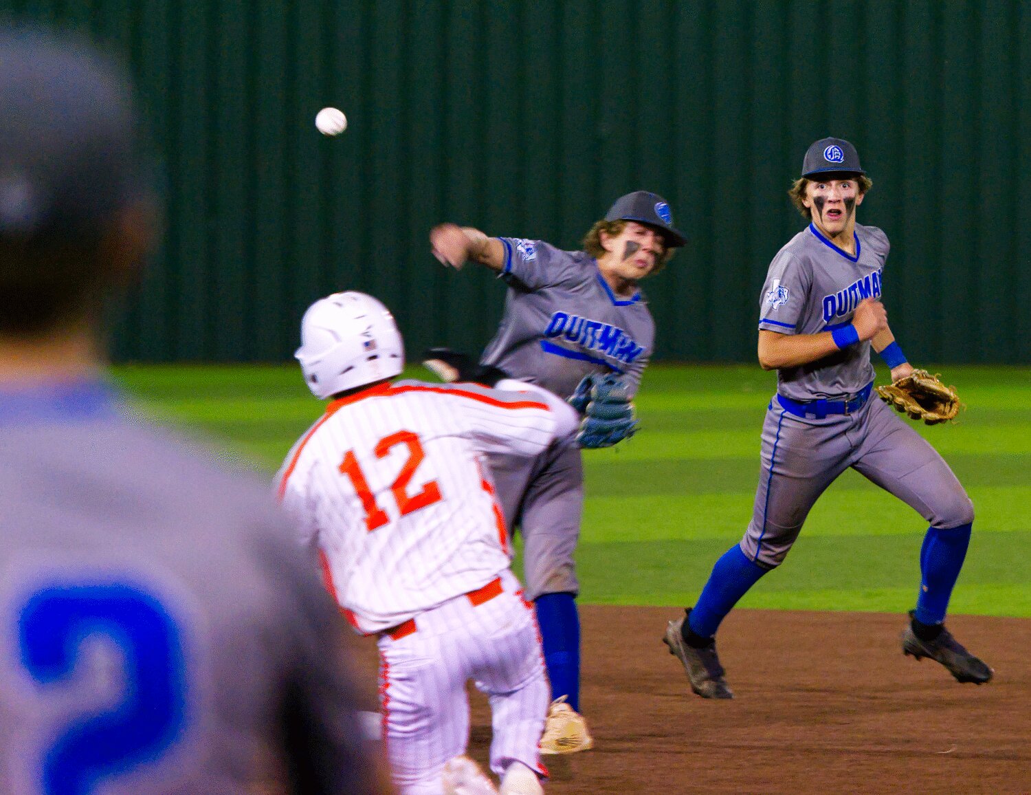 Quitman second baseman Payton Sapp fires the ball over a sliding Jacob Castleberry to turn a double player after receiving a toss from shortstop Davis Watson. [more photos]